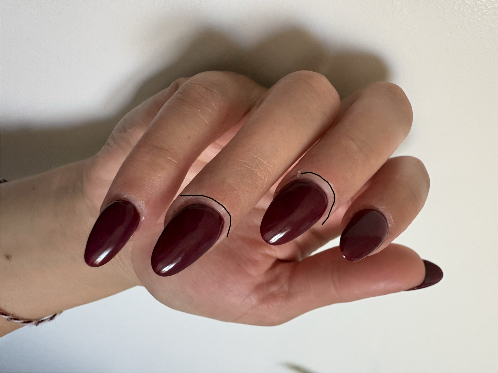 Glossy maroon almond manicure