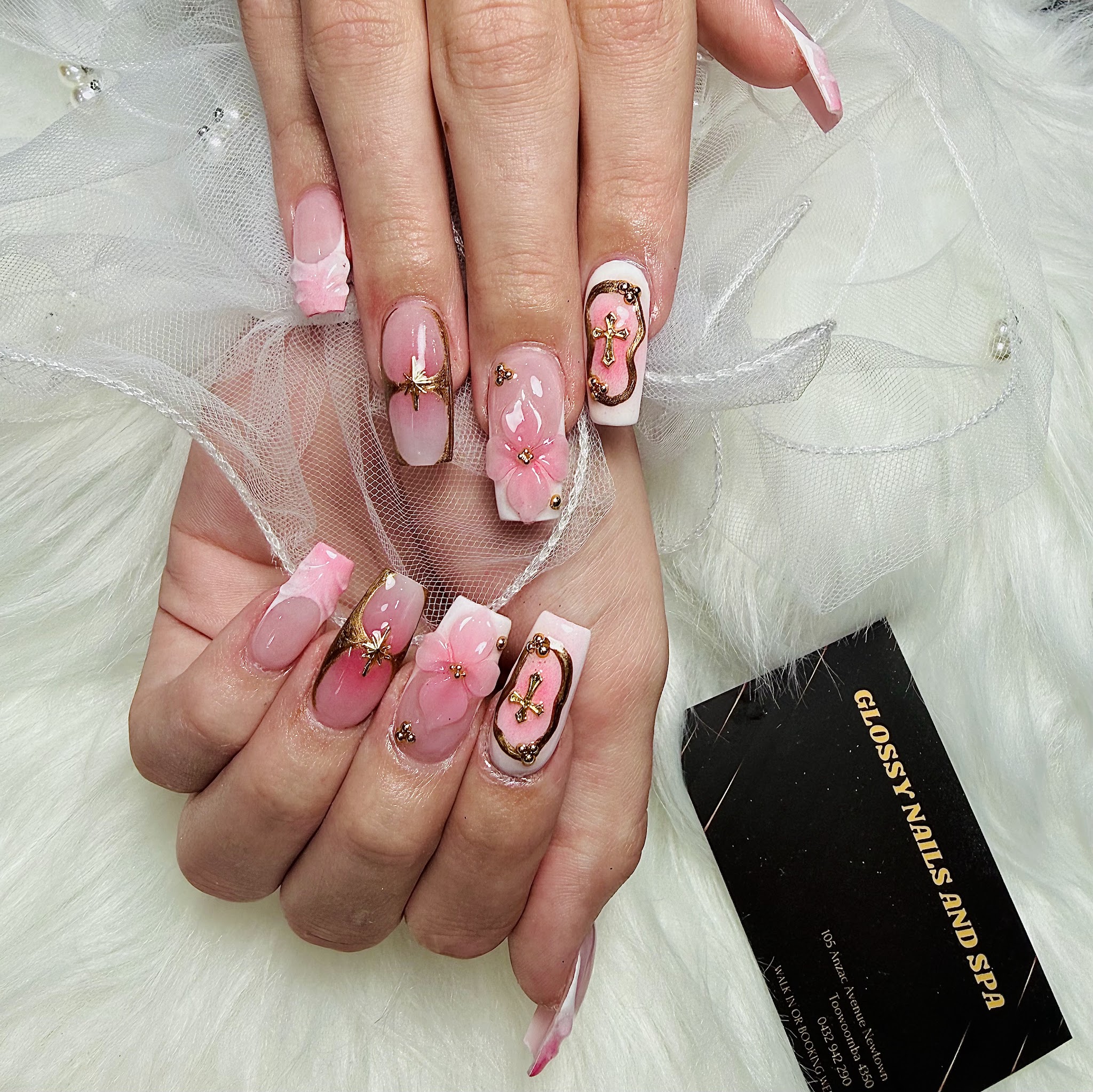 Pink 3D nail art with gold floral and cross details