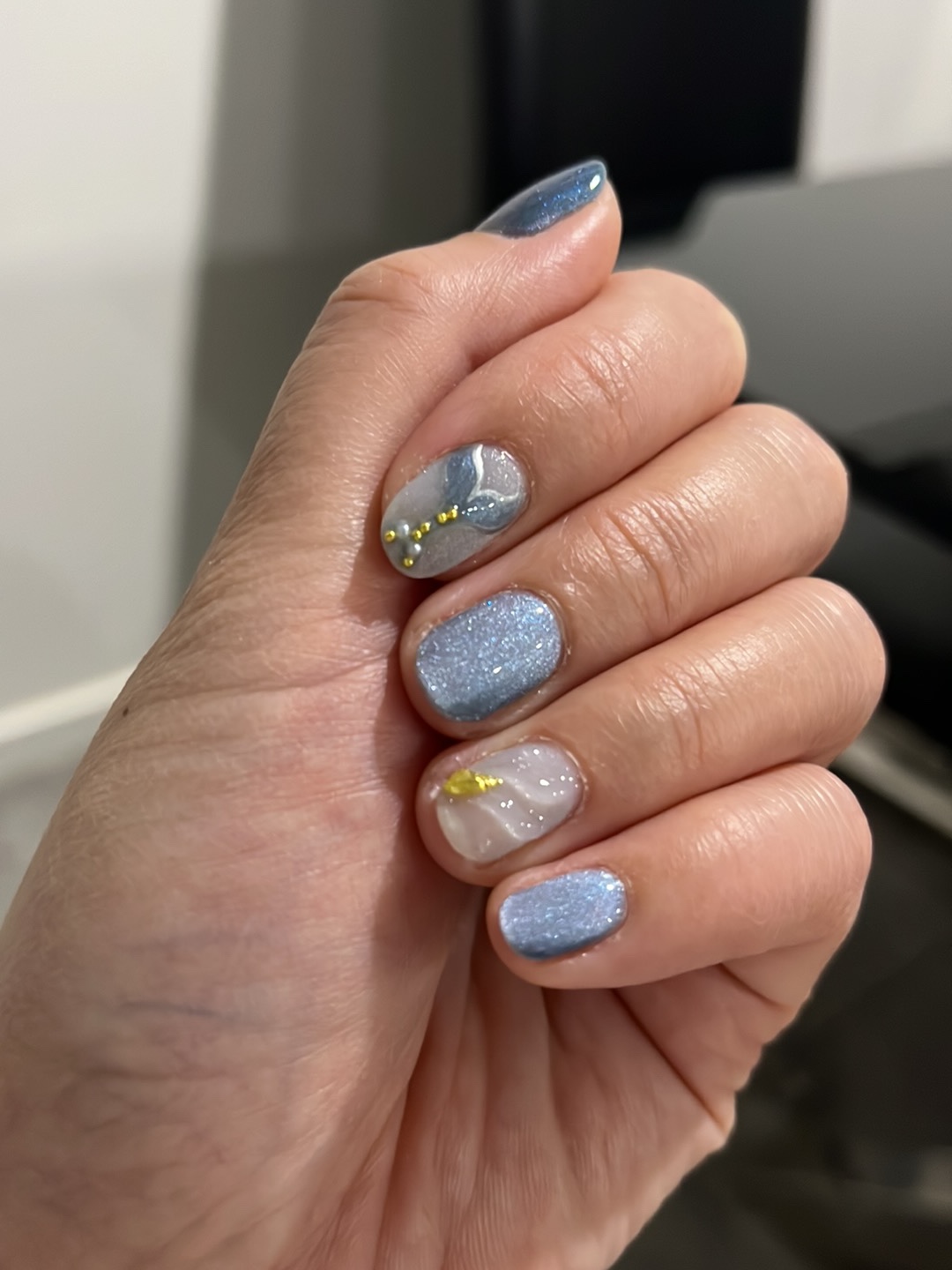 Blue and silver glitter manicure with an art accent nail